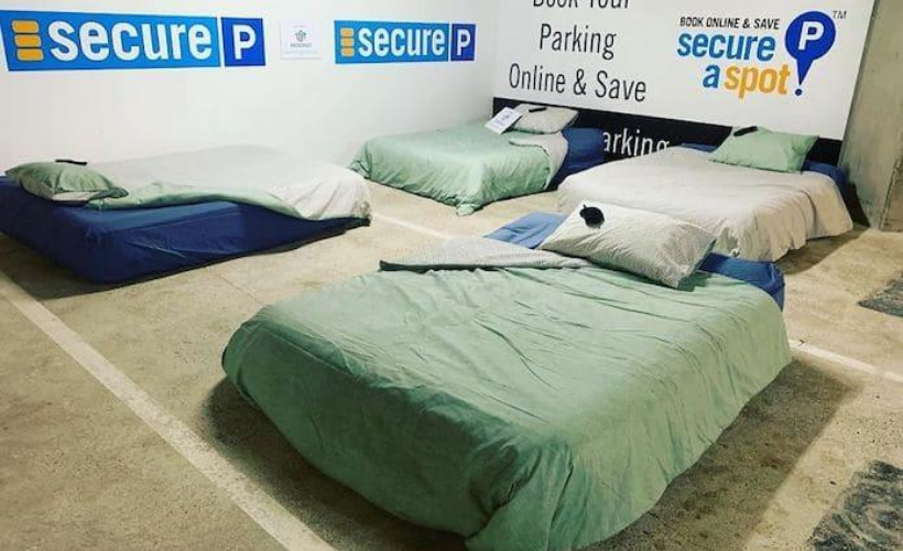 A homeless shelter is installed in an underground car park