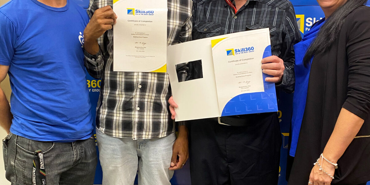 Bedding Down Careers Program Graduates Brian and Daniel smiling with their certificates with Beddown and Busy Ability Team Members